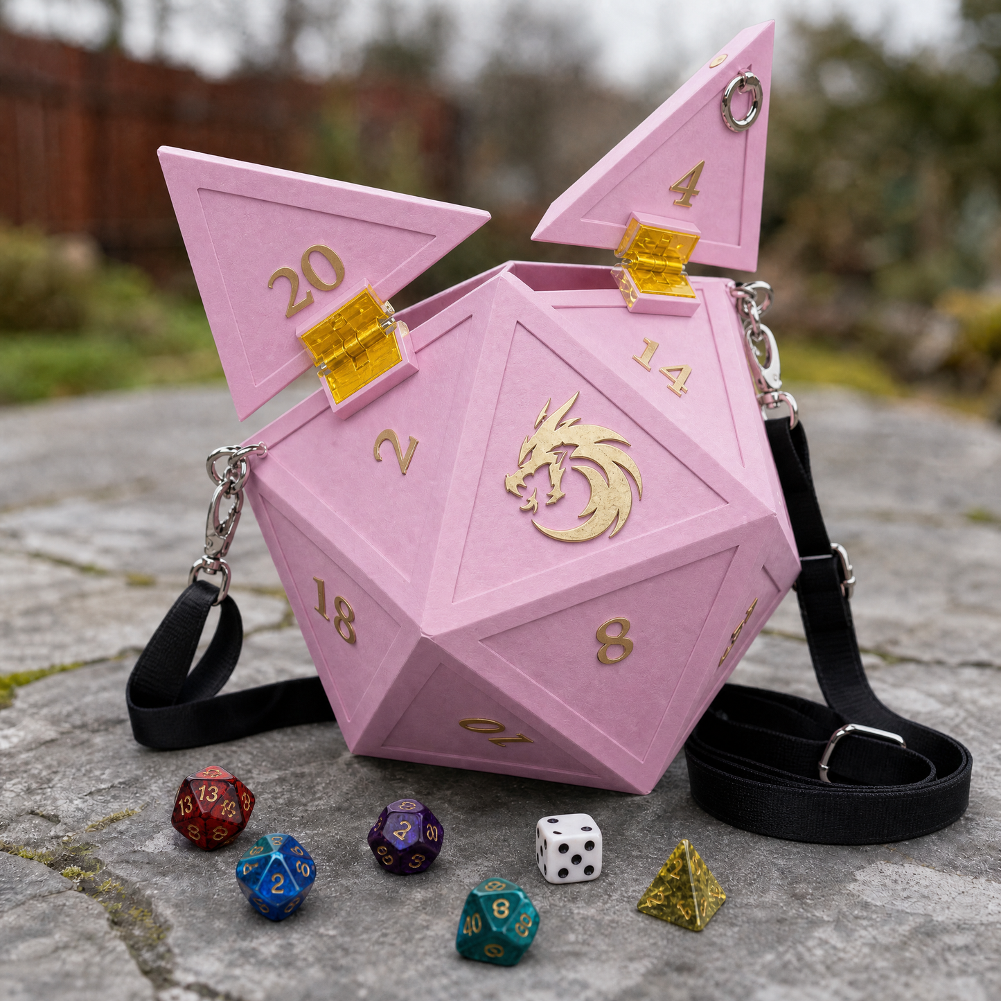 Rose Pink D20 Dice Bag open on amber latches, gold dragon and numerals, black strap, dice scattered on stone